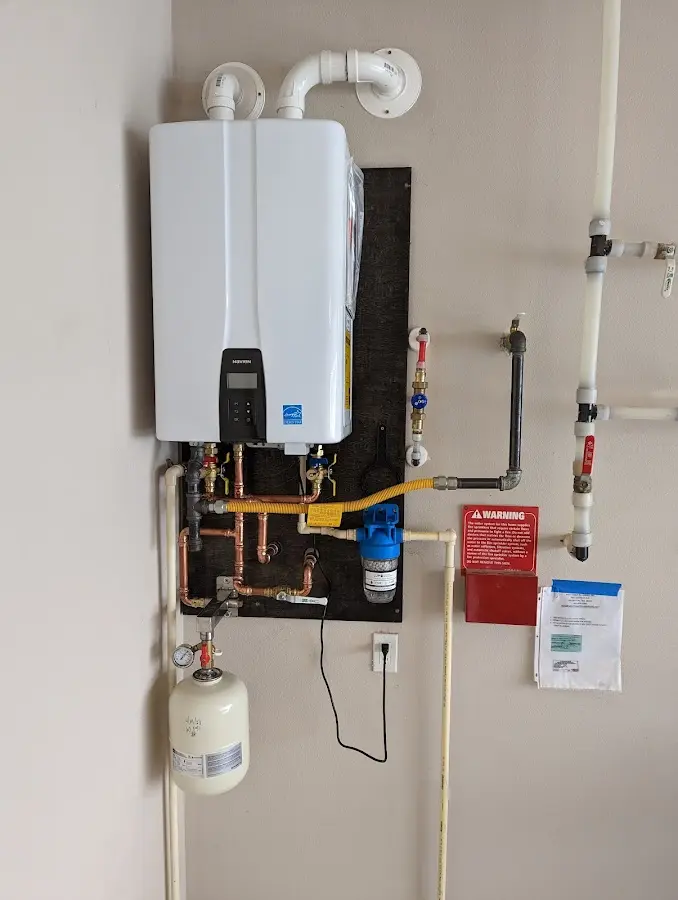 Professional plumber installing copper piping in a Seward home